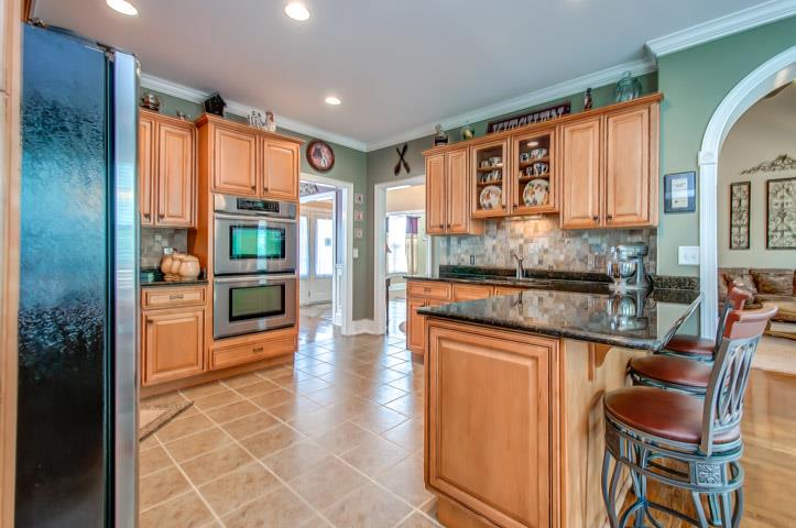 1227 White Rock Road Spring Hill, TN 37174 - Photo 15 of 29 a kitchen with stainless steel appliances granite countertop a stove a sink and a refrigerator