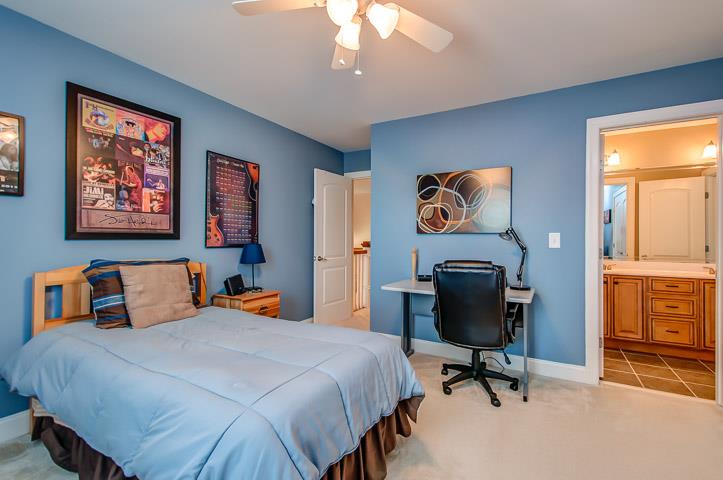 1227 White Rock Road Spring Hill, TN 37174 - Photo 24 of 29 a bedroom with bed and a chandelier