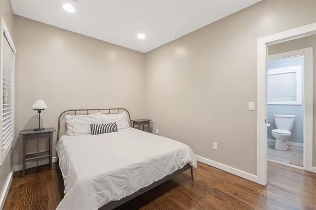 a bedroom with a bed and a table