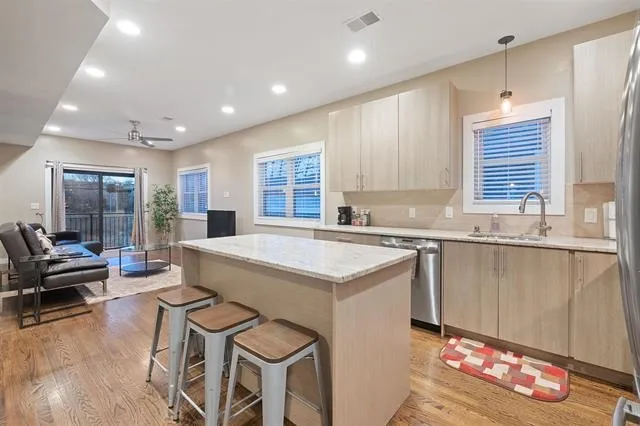 a kitchen with a stove a sink and a refrigerator