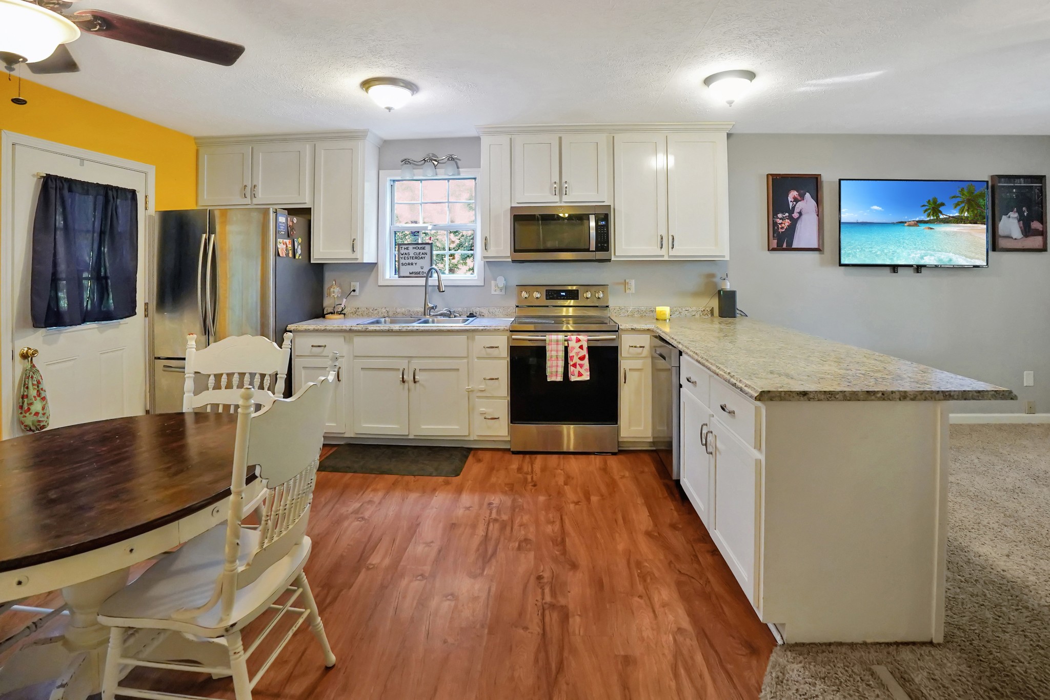 129 Beech Street Dover, TN 37058 - Photo 6 of 27 a large kitchen with stainless steel appliances granite countertop lots of counter top space and wooden floor