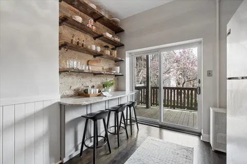 a kitchen with a table chairs and glass door