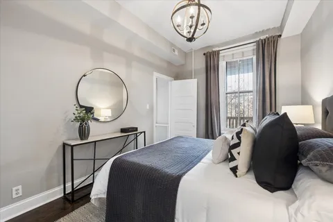 a bedroom with bed and a window