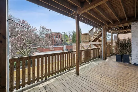 a view of a balcony with wooden floor