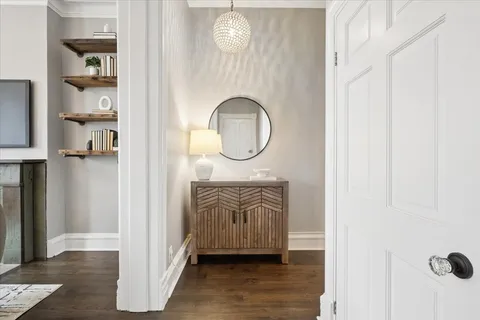 a front view of a house with entryway wooden floor and front door