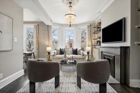 a living room with fireplace furniture and a flat screen tv