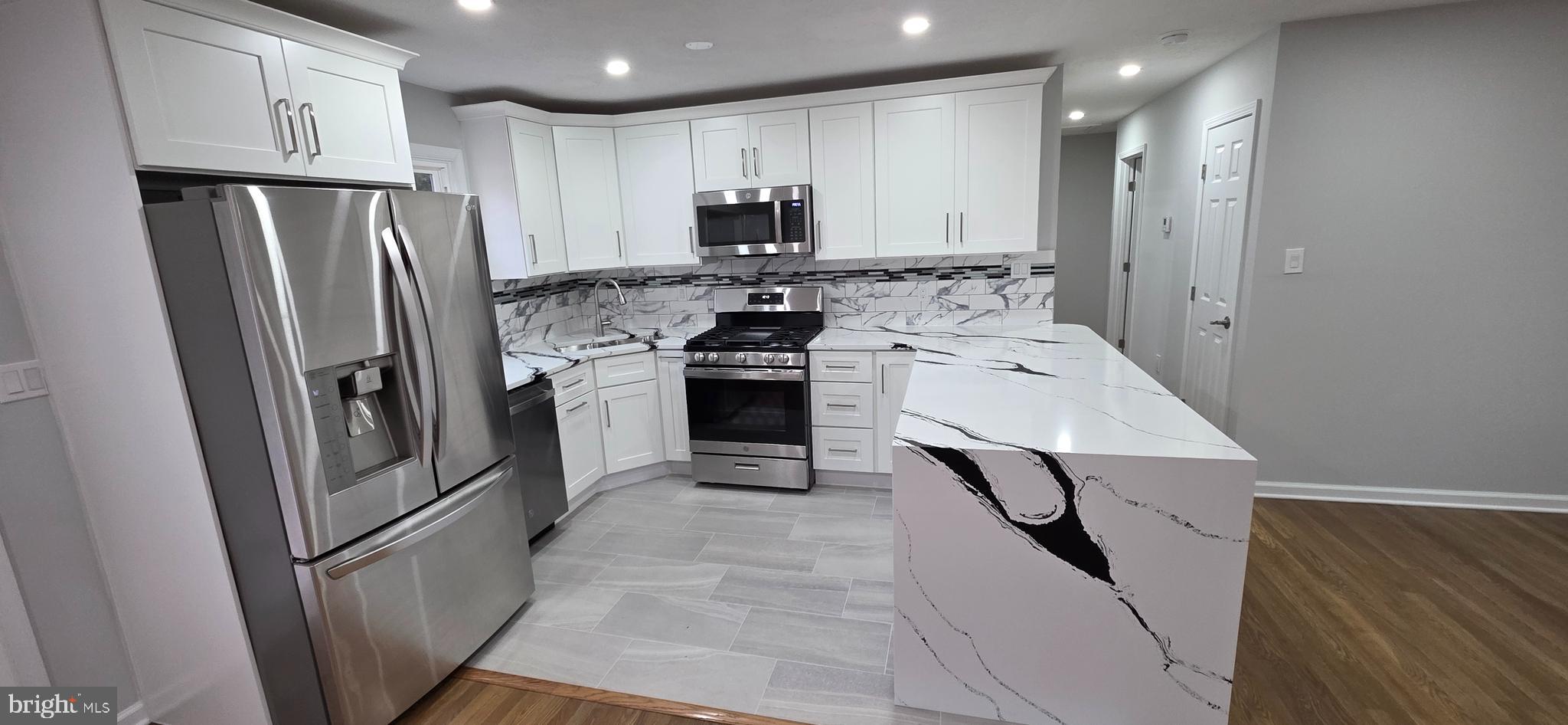 4813 Lawrence Street Alexandria, VA 22309 - Photo 15 of 66 a kitchen with stainless steel appliances granite countertop a refrigerator stove and sink