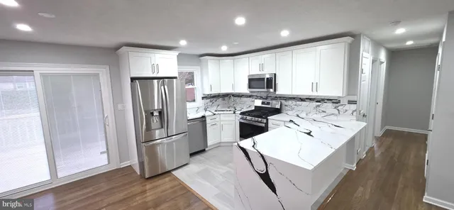 a kitchen with refrigerator and cabinets