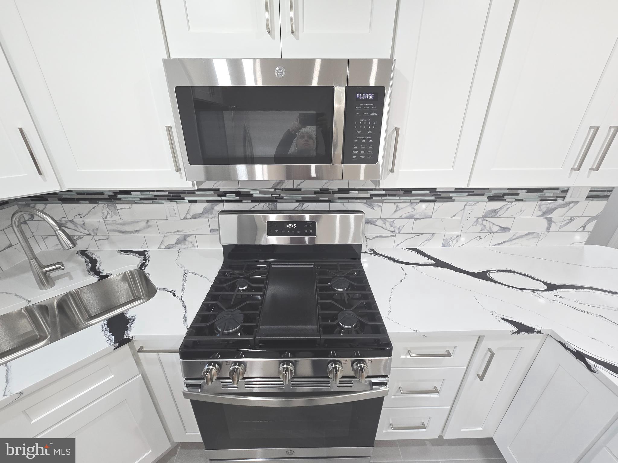 4813 Lawrence Street Alexandria, VA 22309 - Photo 19 of 66 a stove top oven sitting inside of a kitchen