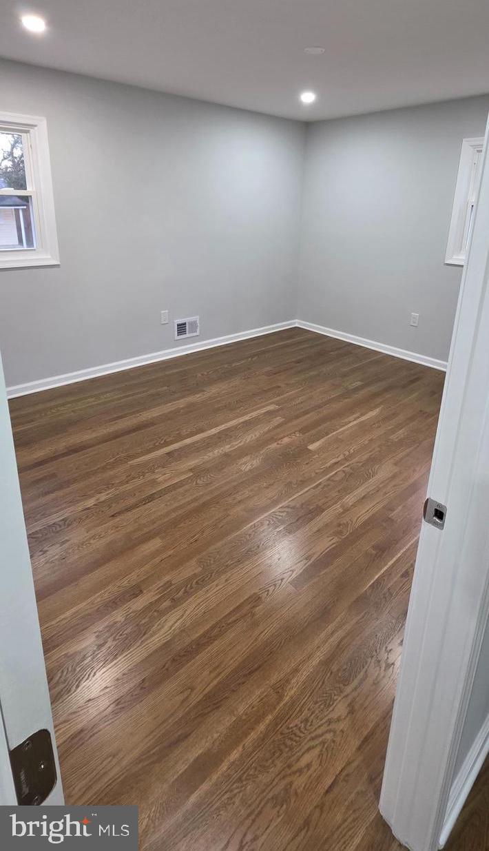 4813 Lawrence Street Alexandria, VA 22309 - Photo 24 of 66 an empty room with wooden floor and windows