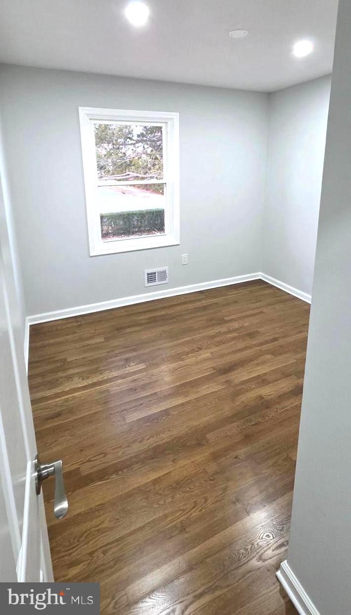 4813 Lawrence Street Alexandria, VA 22309 - Photo 25 of 66 an empty room with wooden floor and windows