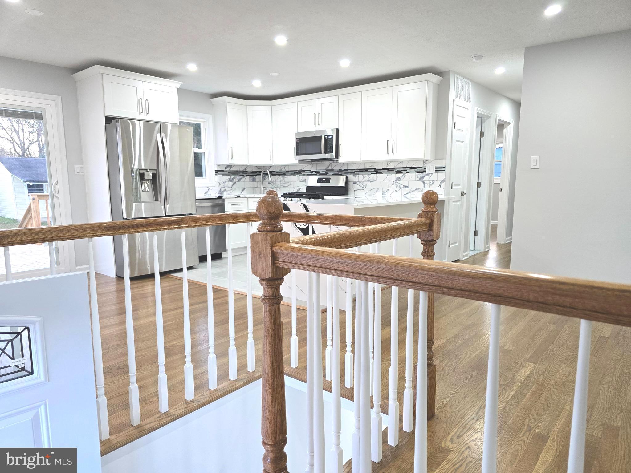 4813 Lawrence Street Alexandria, VA 22309 - Photo 27 of 66 a kitchen with stainless steel appliances granite countertop a refrigerator sink and cabinets