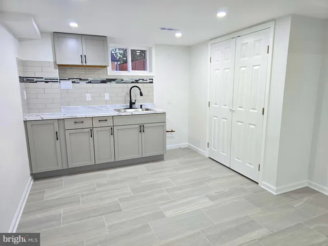 a view of kitchen with cabinets and wooden floor