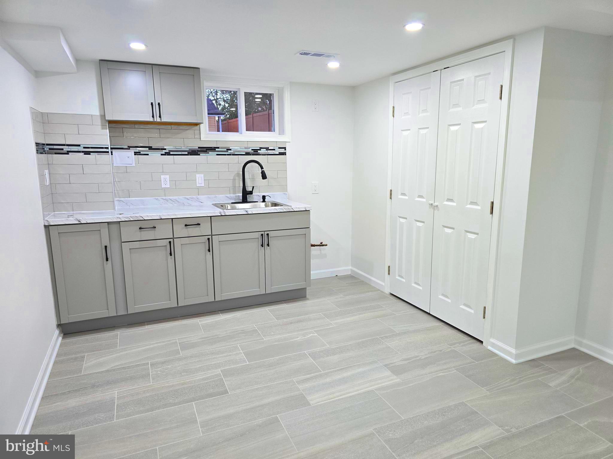 4813 Lawrence Street Alexandria, VA 22309 - Photo 42 of 66 a large kitchen with kitchen island a sink stainless steel appliances and cabinets