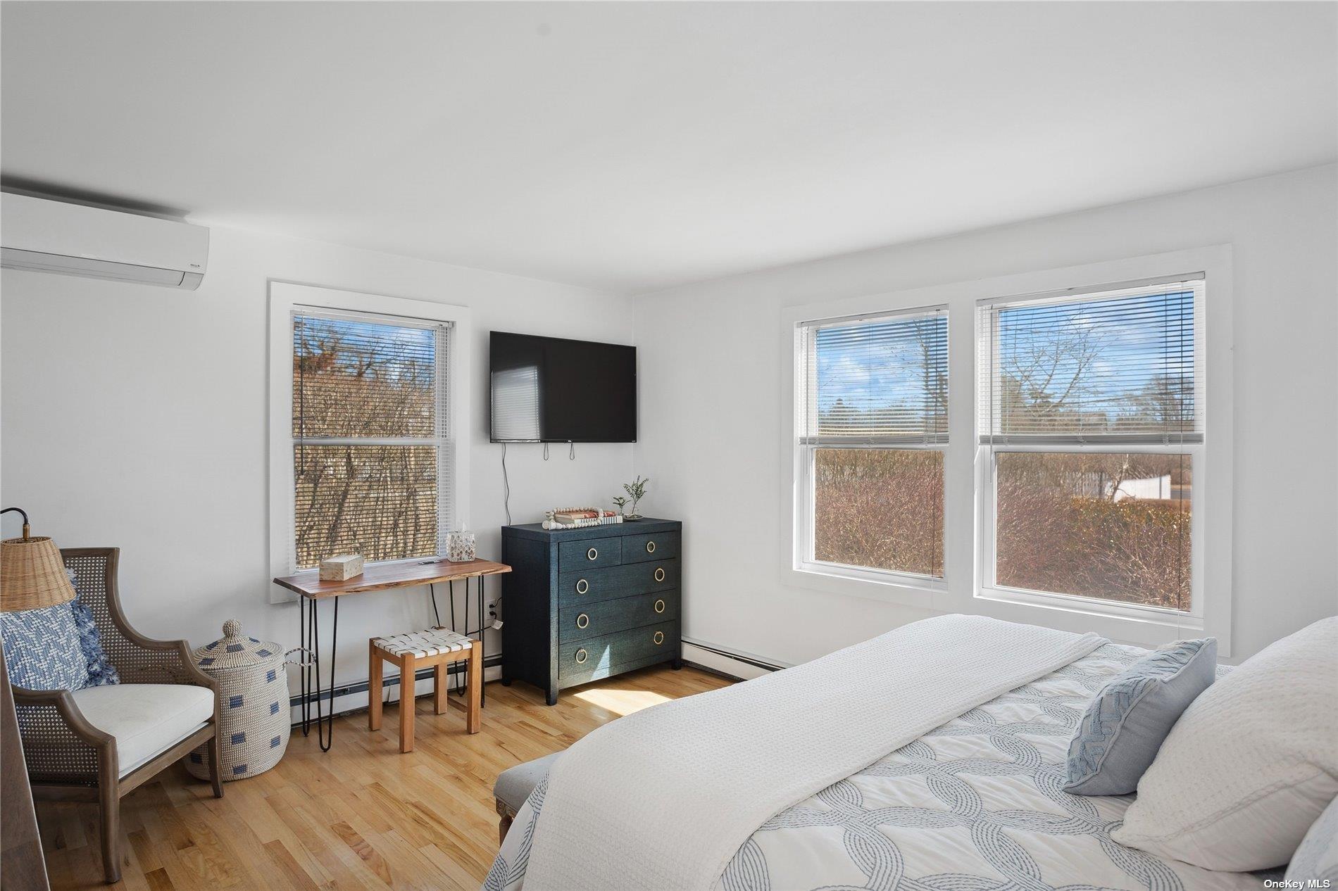 66 Library Avenue Westhampton Beach, NY 11978 - Photo 14 of 26 a bedroom with a bed and a tv on table