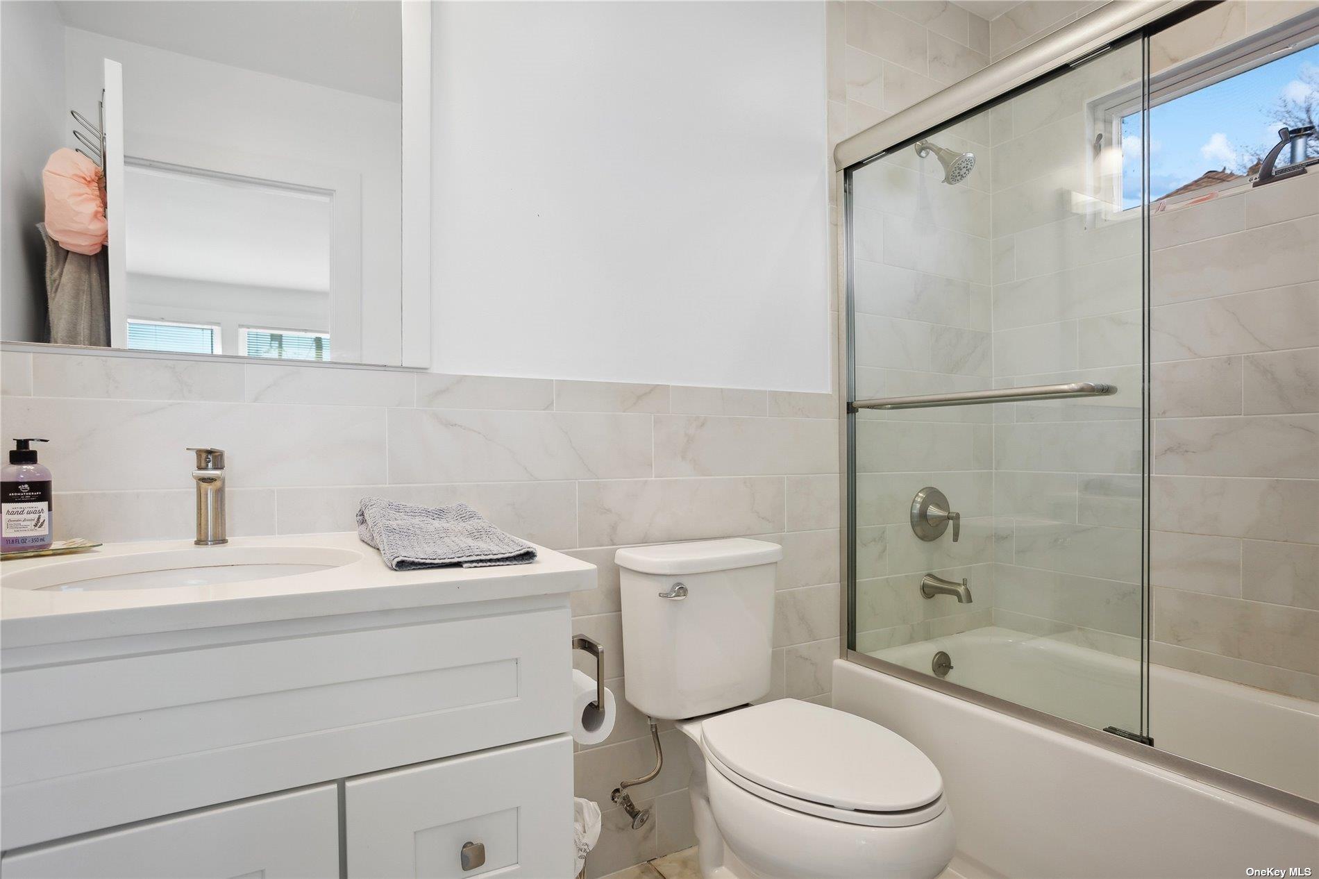 66 Library Avenue Westhampton Beach, NY 11978 - Photo 17 of 26 a bathroom with a sink toilet and shower