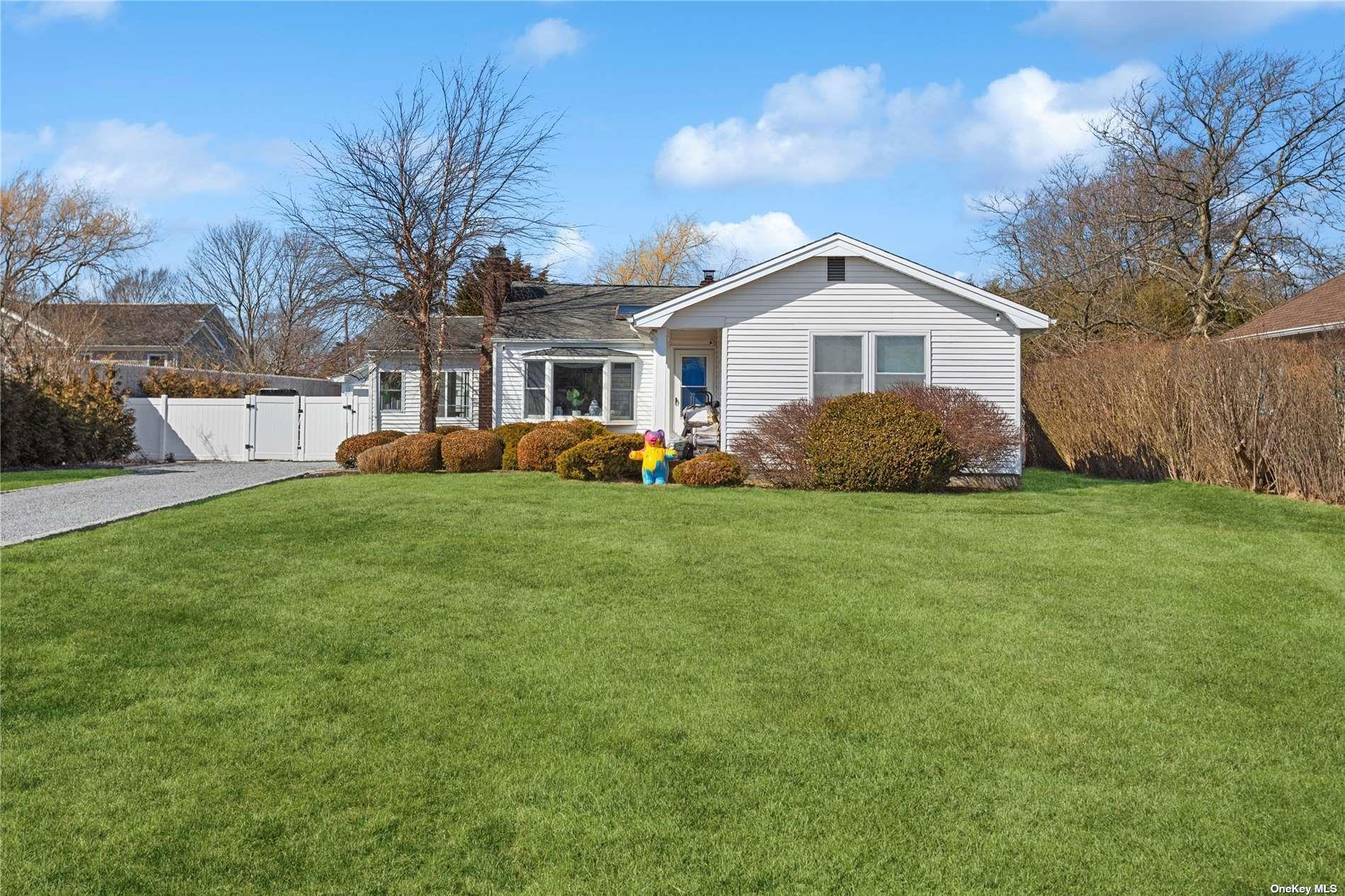 66 Library Avenue Westhampton Beach, NY 11978 - Photo 2 of 26 a front view of house with yard and green space