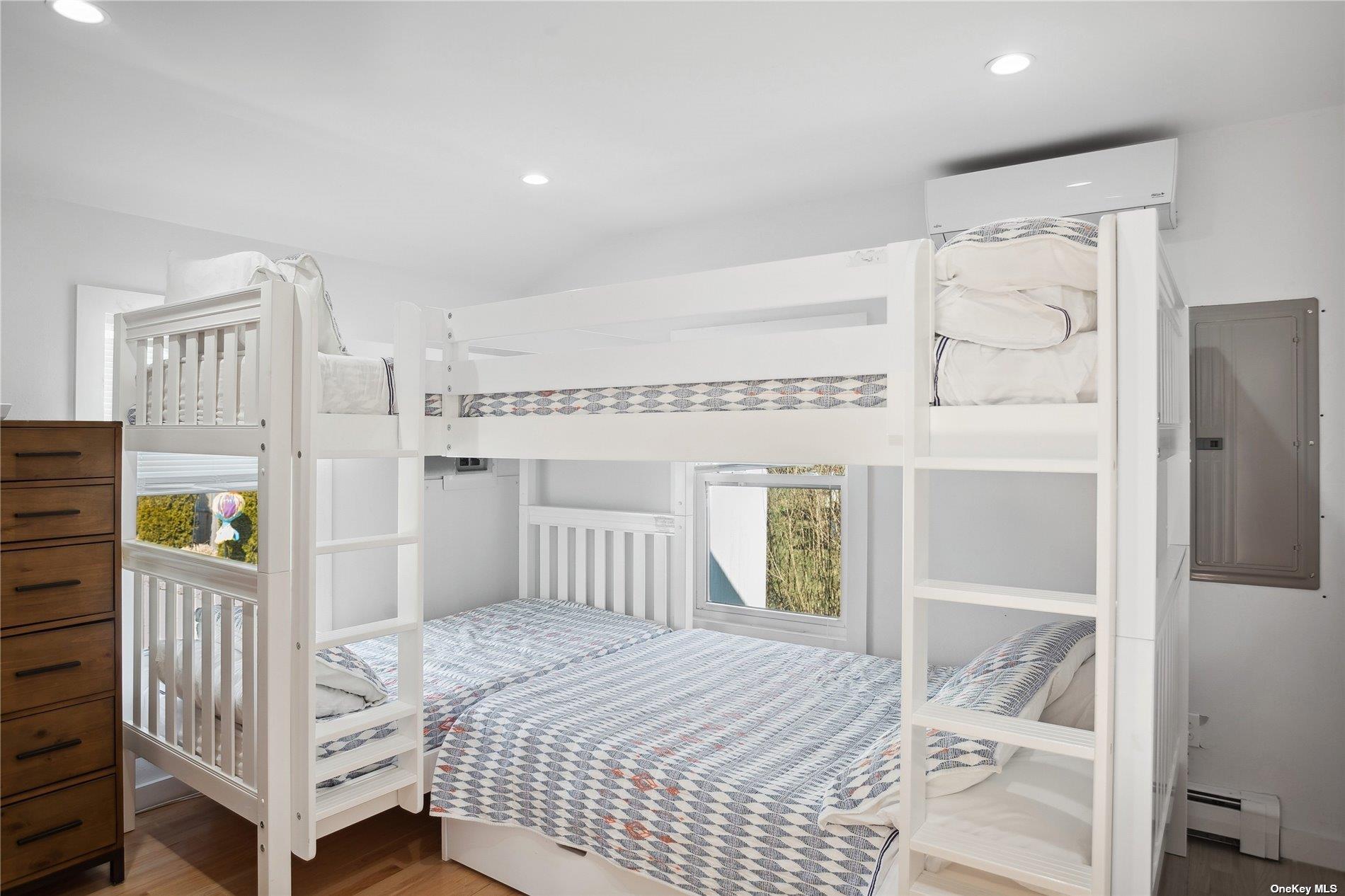 66 Library Avenue Westhampton Beach, NY 11978 - Photo 22 of 26 a bedroom with a bed and a window