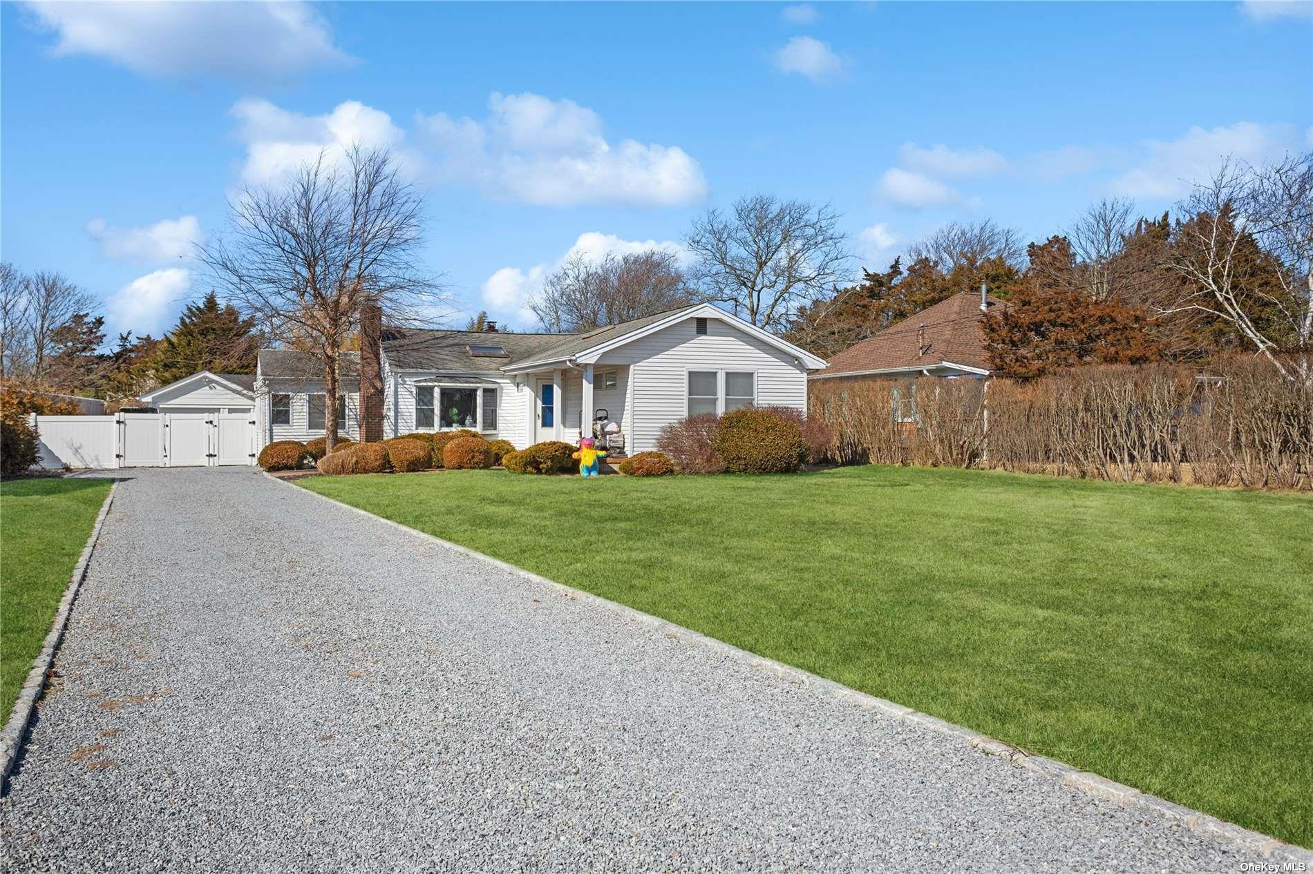 66 Library Avenue Westhampton Beach, NY 11978 - Photo 25 of 26 a view of house with a big yard and large trees