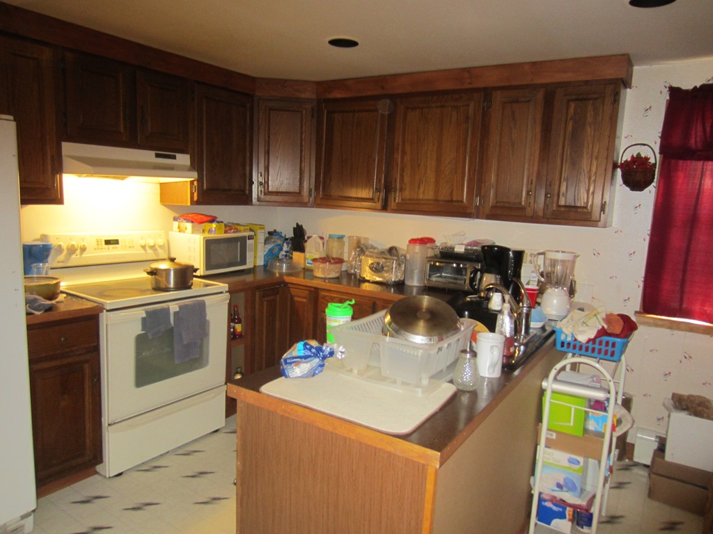 299-301 Winslow Gray Road Yarmouth, MA 02673 - Photo 13 of 15 a kitchen with a sink and a stove top oven