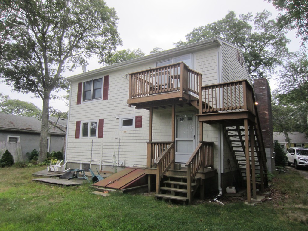 299-301 Winslow Gray Road Yarmouth, MA 02673 - Photo 2 of 15 a view of a house with backyard and porch