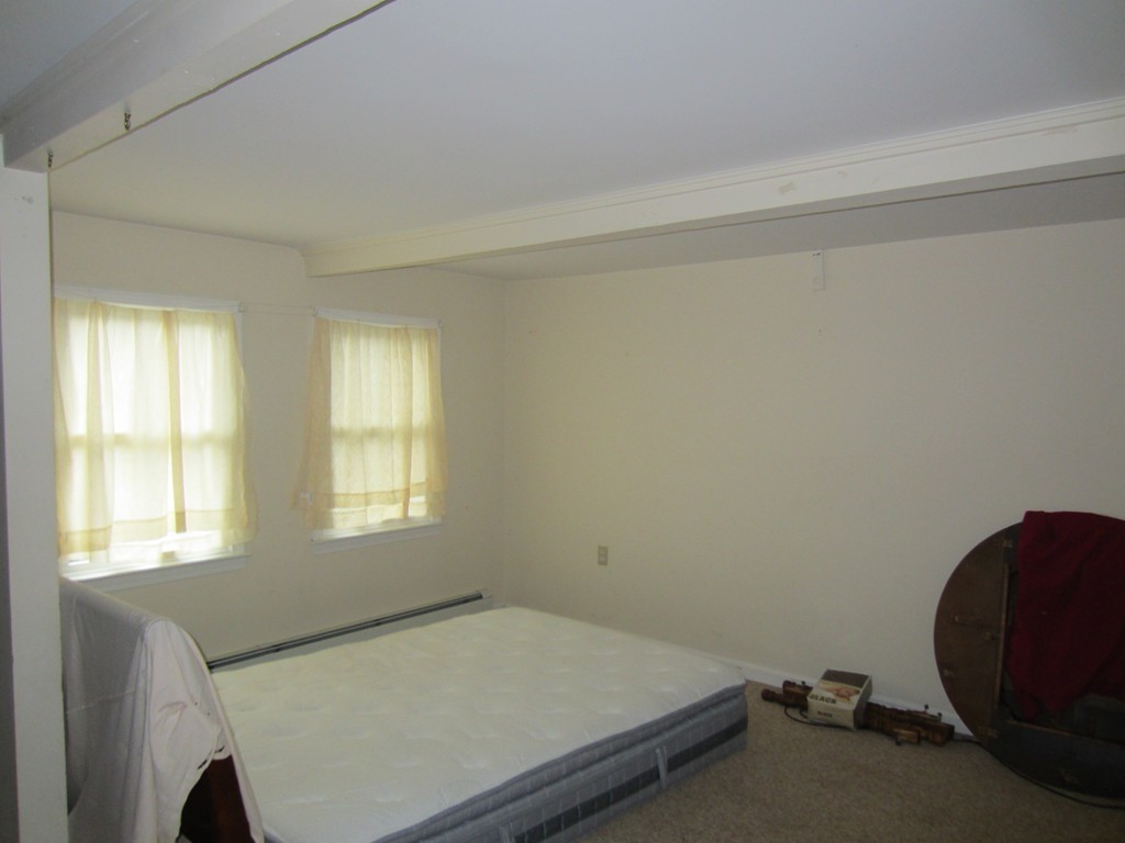 299-301 Winslow Gray Road Yarmouth, MA 02673 - Photo 3 of 15 a room with a bed and windows