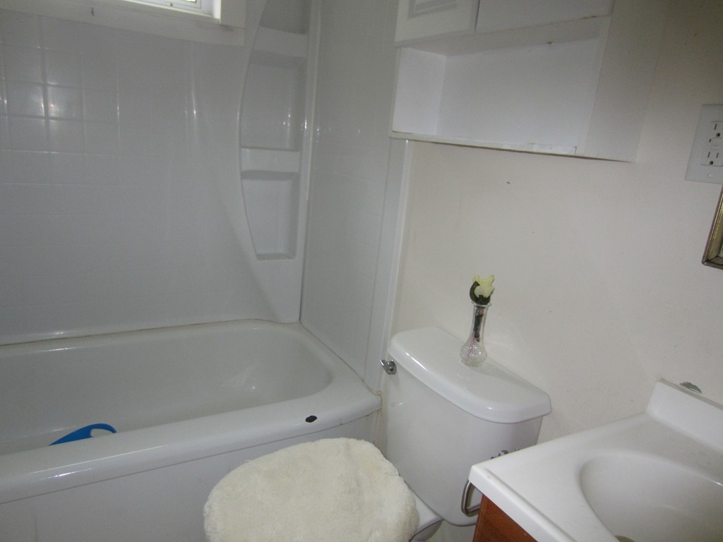 299-301 Winslow Gray Road Yarmouth, MA 02673 - Photo 6 of 15 a bath room with a toilet a sink and a bath tub