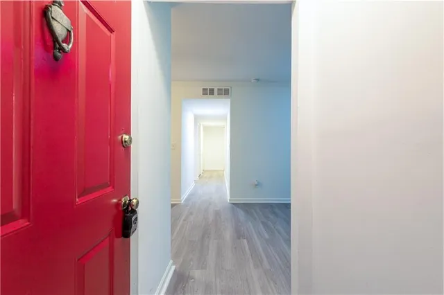 a view of a hallway with wooden floor