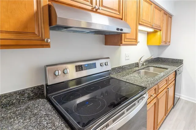 a kitchen that has a sink and a stove