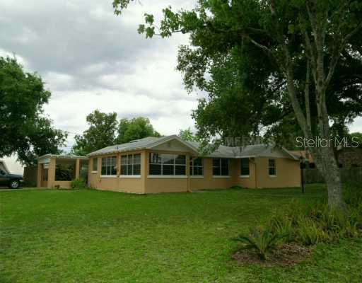 49 Bonita Road DeBary, FL 32713 - Photo 1 of 1 a view of a house next to a big yard and large trees