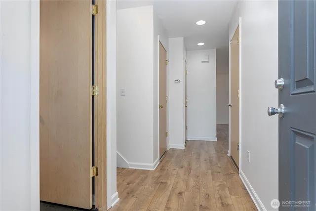 a view of hallway with wooden floor