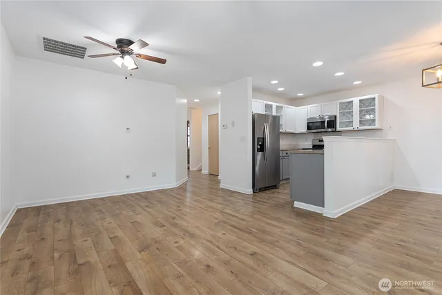 a view of a kitchen with a sink and stainless steel appliances