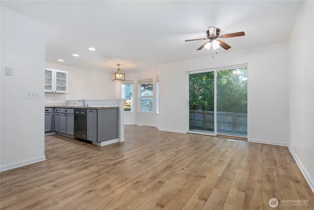 a view of kitchen with granite countertop cabinets and wooden floor