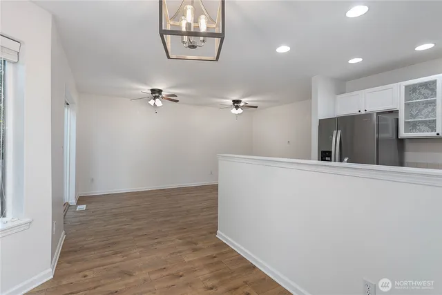 a view of a hallway with wooden floor
