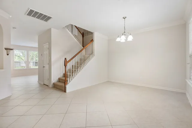 a view of entryway and hall with a chandelier