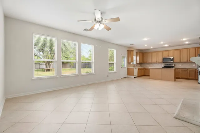 a view of a livingroom with furniture cabinets and window