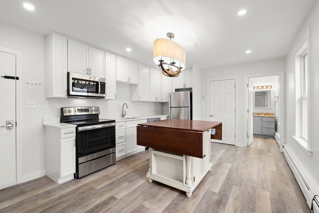 17 3rd Street, Unit 17 North Andover, MA 01845 - Photo 1 of 12 a kitchen with stainless steel appliances granite countertop a stove a sink and a refrigerator