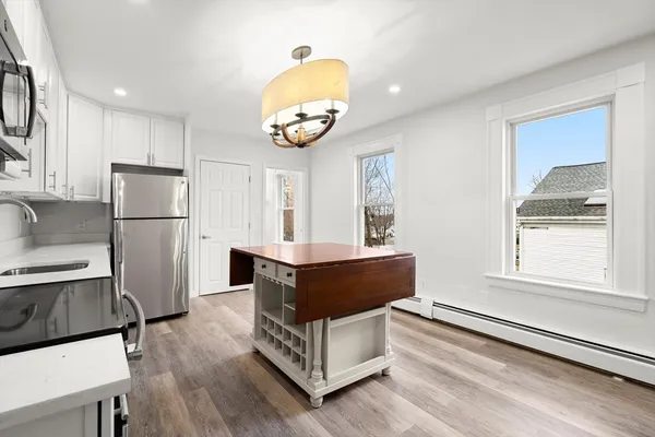 a kitchen with stainless steel appliances granite countertop a refrigerator and a stove