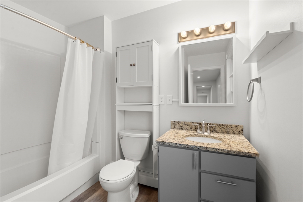 17 3rd Street, Unit 17 North Andover, MA 01845 - Photo 4 of 12 a bathroom with a granite countertop sink toilet and shower