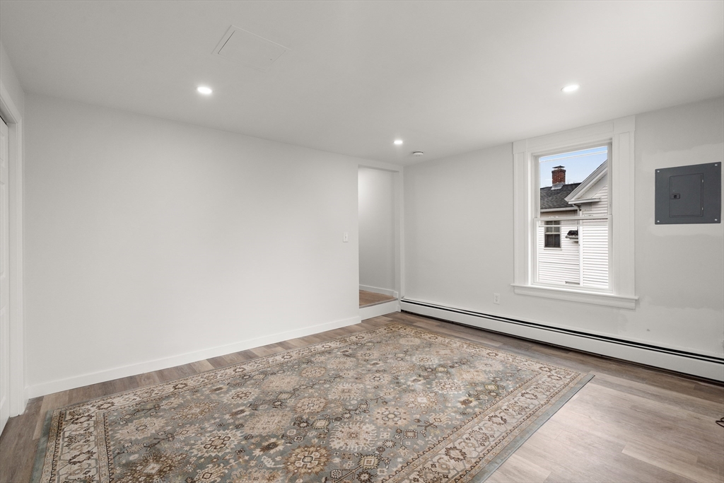 17 3rd Street, Unit 17 North Andover, MA 01845 - Photo 6 of 12 an empty room with wooden floor and windows