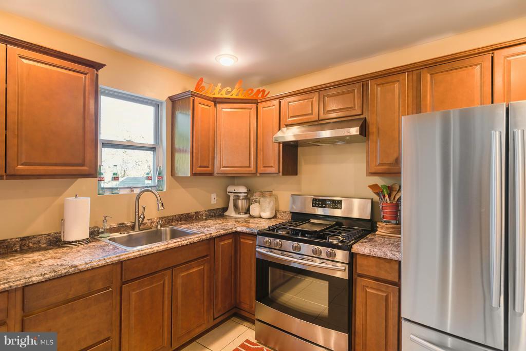 5014 Morello Road Baltimore, MD 21214 - Photo 5 of 29 a kitchen with stainless steel appliances granite countertop a refrigerator sink and stove