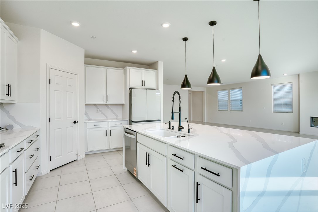 3777 Alla Rocca Avenue Henderson, NV 89044 - Photo 15 of 55 Kitchen featuring light stone countertops, white cabinetry, hanging light fixtures, a kitchen island with sink, and recessed lighting
