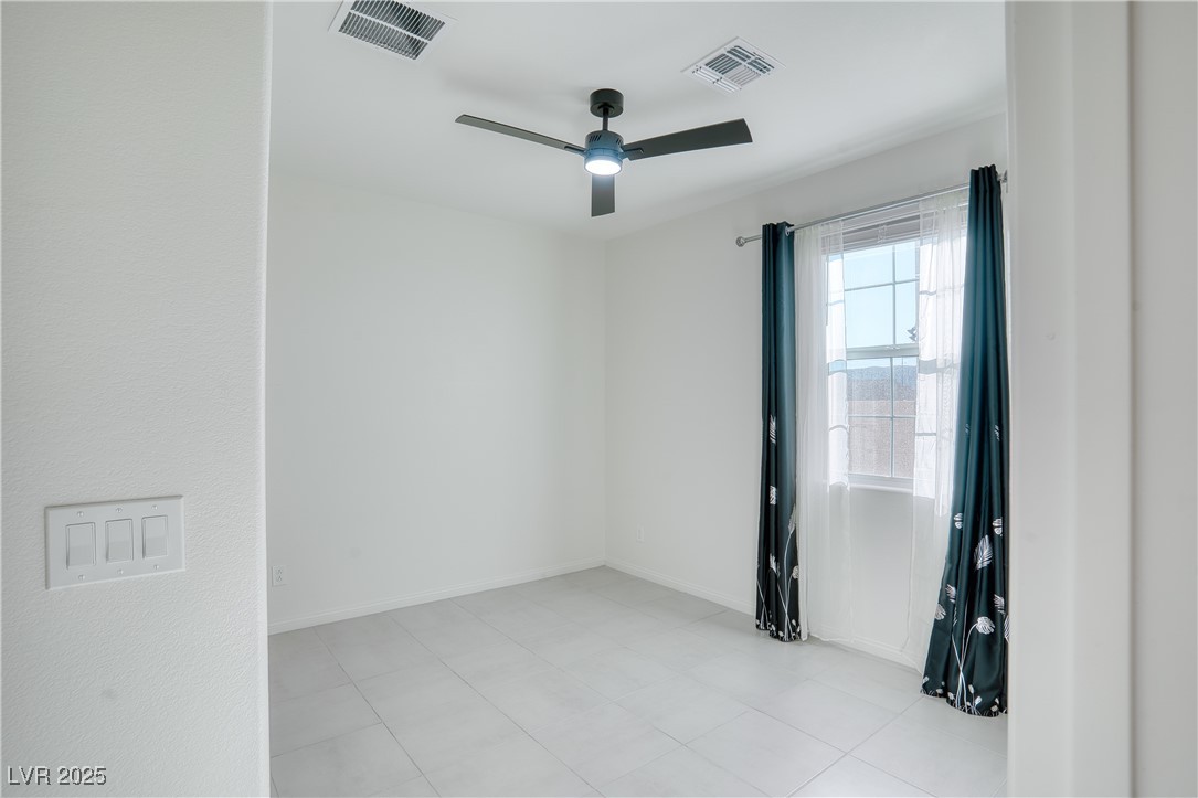 3777 Alla Rocca Avenue Henderson, NV 89044 - Photo 16 of 55 Unfurnished room with a ceiling fan and light tile patterned flooring, downstairs