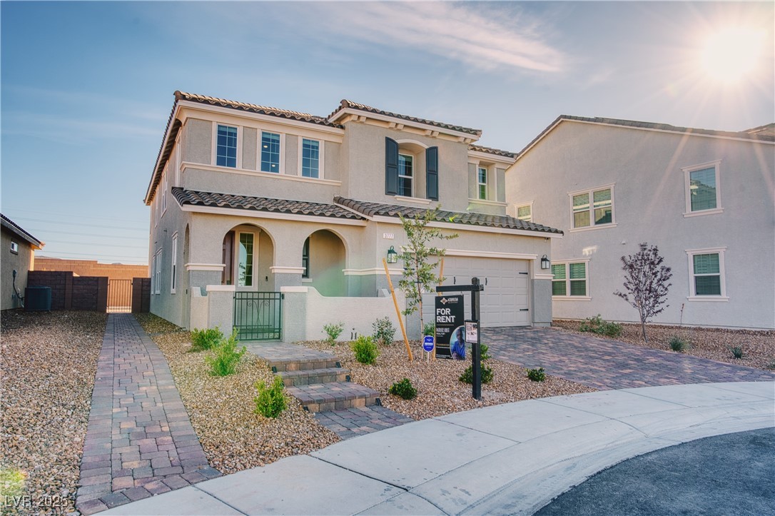 3777 Alla Rocca Avenue Henderson, NV 89044 - Photo 2 of 55 Mediterranean / spanish-style house featuring a porch, stucco siding, decorative driveway, a tiled roof, and a gate