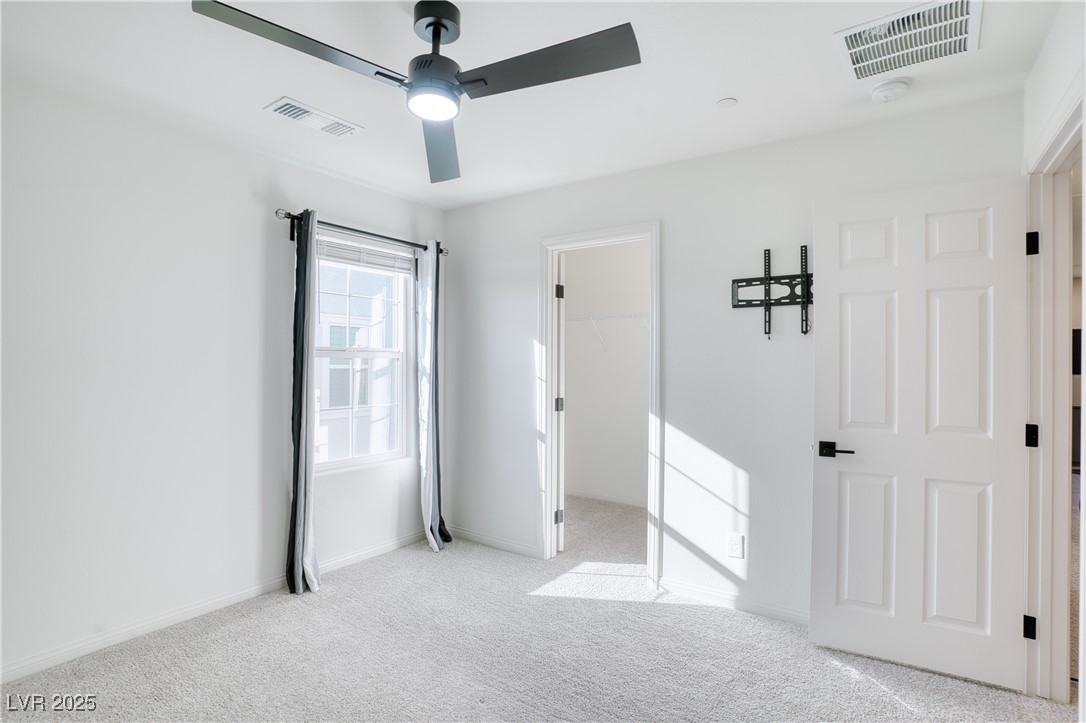 3777 Alla Rocca Avenue Henderson, NV 89044 - Photo 29 of 55 Unfurnished bedroom featuring a spacious closet, carpet, and a ceiling fan