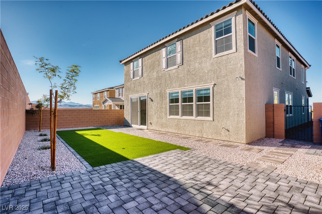 3777 Alla Rocca Avenue Henderson, NV 89044 - Photo 42 of 55 Rear view of property featuring a fenced backyard, stucco siding, a patio, and a gate