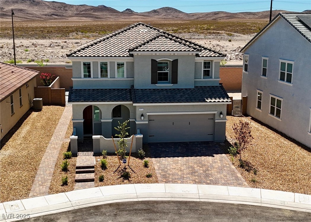 3777 Alla Rocca Avenue Henderson, NV 89044 - Photo 43 of 55 Mediterranean / spanish-style house with stucco siding, an attached garage, decorative driveway, and a mountain view