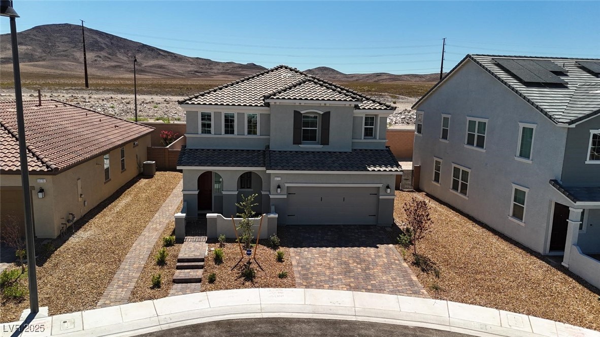 3777 Alla Rocca Avenue Henderson, NV 89044 - Photo 44 of 55 View of front of house with stucco siding, decorative driveway, a garage, a tile roof, and a mountain view