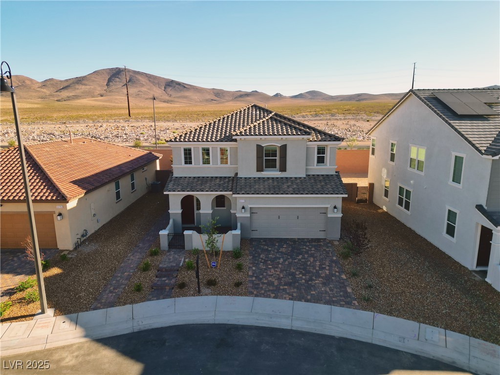 3777 Alla Rocca Avenue Henderson, NV 89044 - Photo 46 of 55 Mediterranean / spanish house featuring stucco siding, an attached garage, driveway, a mountain view, and a porch