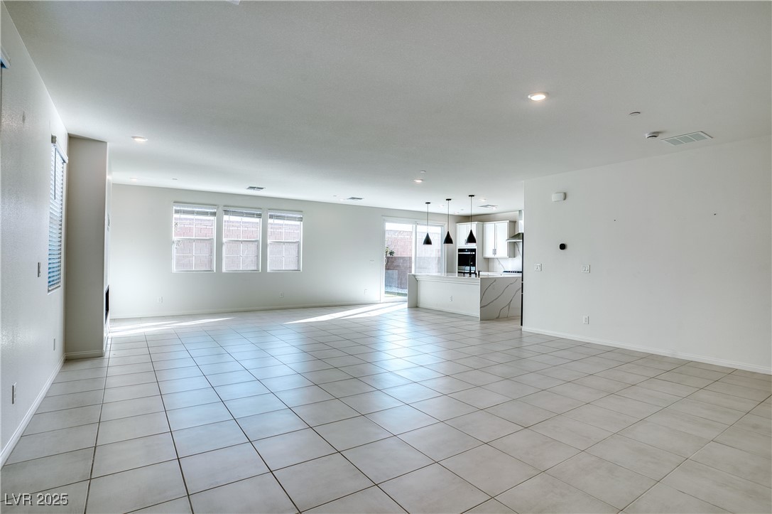 3777 Alla Rocca Avenue Henderson, NV 89044 - Photo 8 of 55 Unfurnished living room featuring light tile patterned floors and baseboards